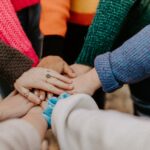 person igirl friends hands piled togethger